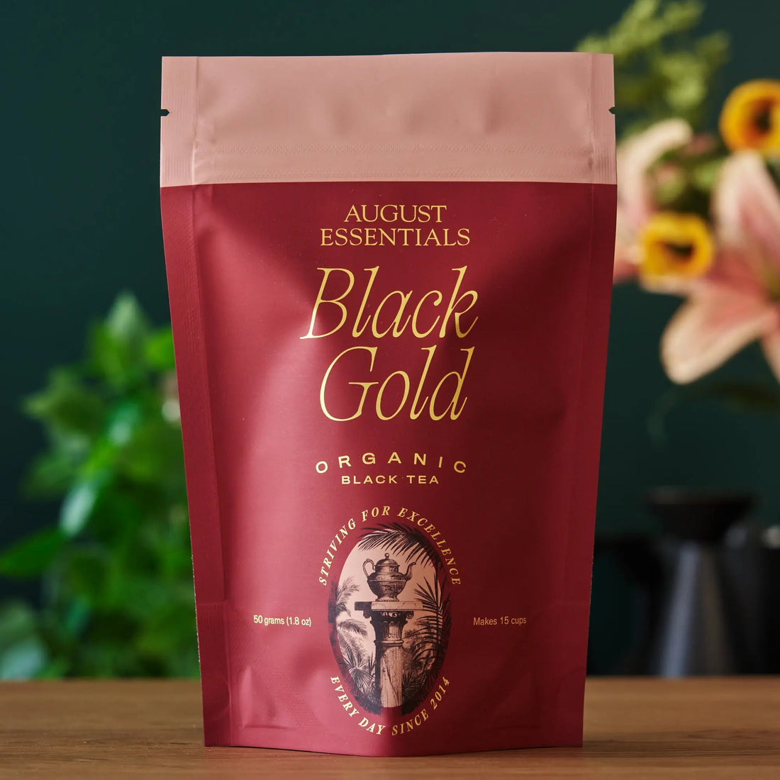 Bag of August Uncommon Tea Essentials Black Gold black tea in a 15-cup package, with a focus on the tea bag and branding.