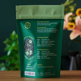 Bright green tea bag of August Uncommon Tea Essentials Bright Green Green Tea, ready for brewing in a 15-cup bag.