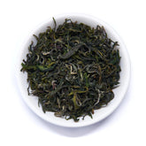 Single estate Pi Lo Chun green tea leaves from Rare Leaves Emerald by August Uncommon Tea, showcasing fresh, twisted green tea leaves.