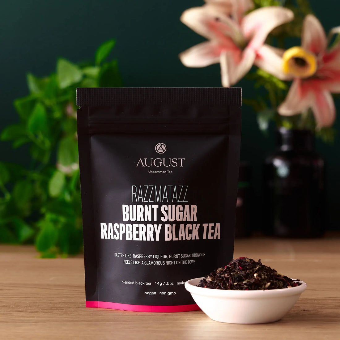 Razzmatazz raspberry burnt sugar black tea in a cup from August Uncommon Tea, showcasing rich dark tea with berry and caramel notes.
