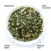 Fresh mint and cucumber herbal tea leaves from Olympus by August Uncommon Tea, caffeine-free beverage.