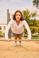 Goal Five Foudy mid-weight long sleeve training top with ½ zip, ideal for outdoor workouts, shown in a fitness setting.