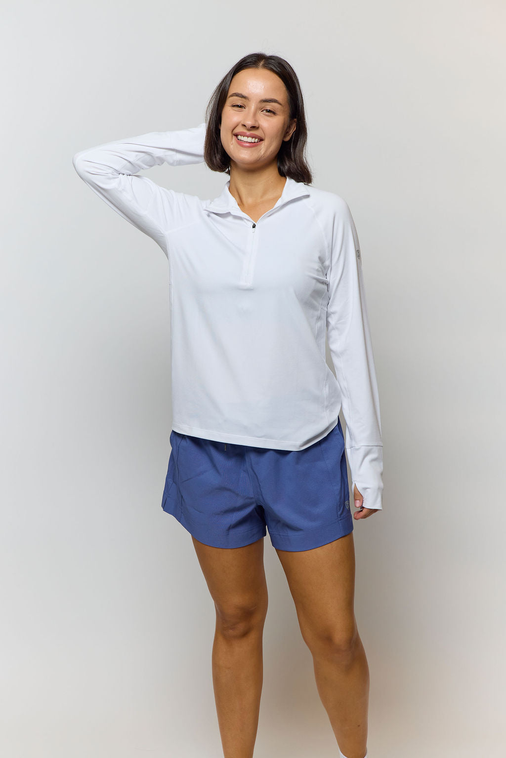 Goal Five Foudy mid-weight long sleeve training top with ½ zip, shown in a casual studio setting.