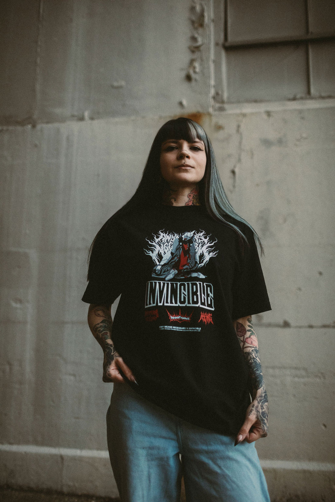Black Neck Snap T-Shirt from Any Means Necessary Clothing, featuring snap button neckline and casual fit for streetwear style.