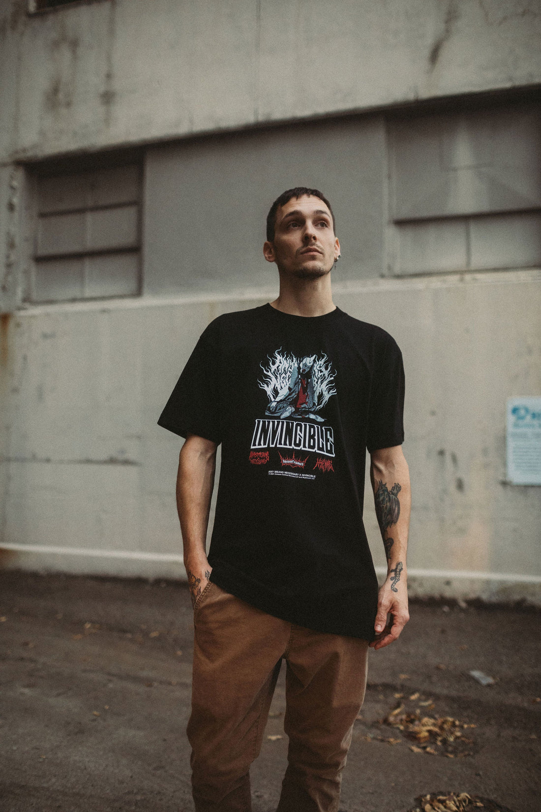 Any Means Necessary Clothing Neck Snap T-Shirt, casual shirt with snap detail, shown in a front view.