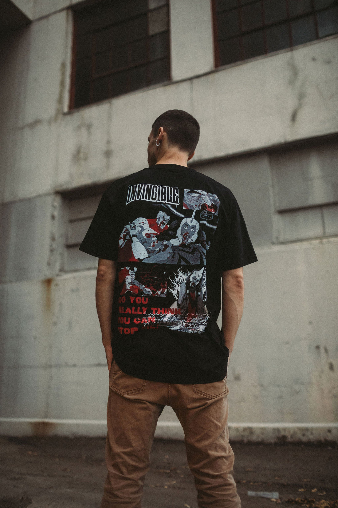 Black Neck Snap T-Shirt from Any Means Necessary Clothing, showing front view with snap button details and crew neckline.