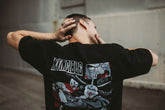 Black Neck Snap T-Shirt from Any Means Necessary Clothing, showing front view with snap button neckline and casual fit.