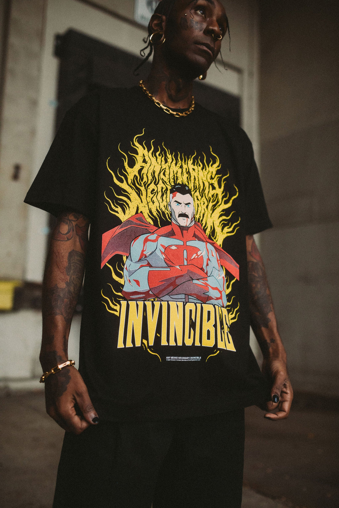 Omni-Man T-shirt from Any Means Necessary Clothing featuring a graphic print of Omni-Man superhero character.