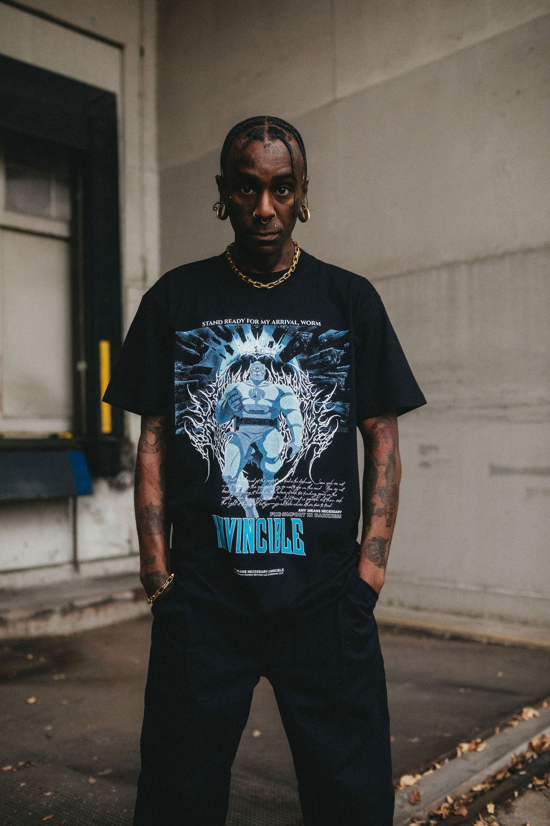 Any Means Necessary Clothing Arrival T-Shirt in black, featuring a front graphic design and casual fit.