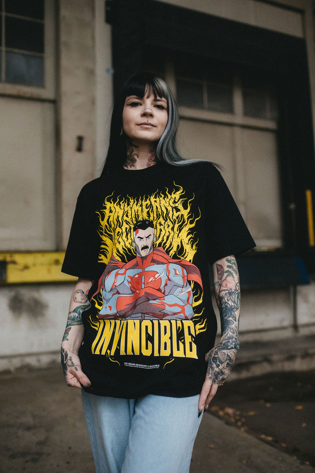 Omni-Man T-shirt from Any Means Necessary Clothing featuring a graphic print of Omni-Man superhero on a casual shirt.