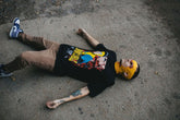 Black Betrayal T-Shirt from Any Means Necessary Clothing featuring a modern graphic design on the front.