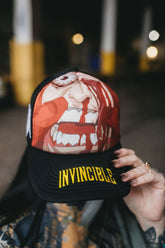 Black Face Smasher Trucker Hat by Any Means Necessary Clothing with mesh back and adjustable snap closure.