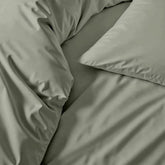 Italic Luxe Australian Sateen Sheet Set on a bed showcasing smooth, silky bed sheets in a cozy bedroom setting.