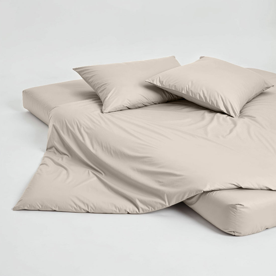 Elegant Luxe Australian Sateen pillowcase set by Italic, featuring smooth, shiny satin fabric on a neatly arranged bed.