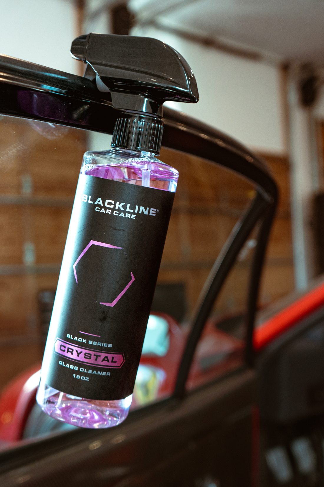 Blackline Car Care BLACKLINE® Crystal Glass Cleaner spray bottle with clear liquid for cleaning car windows and glass surfaces.