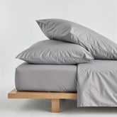 Luxurious Australian sateen sheet set by Italic, featuring smooth, shiny fabric and neatly made beds with matching pillowcases.