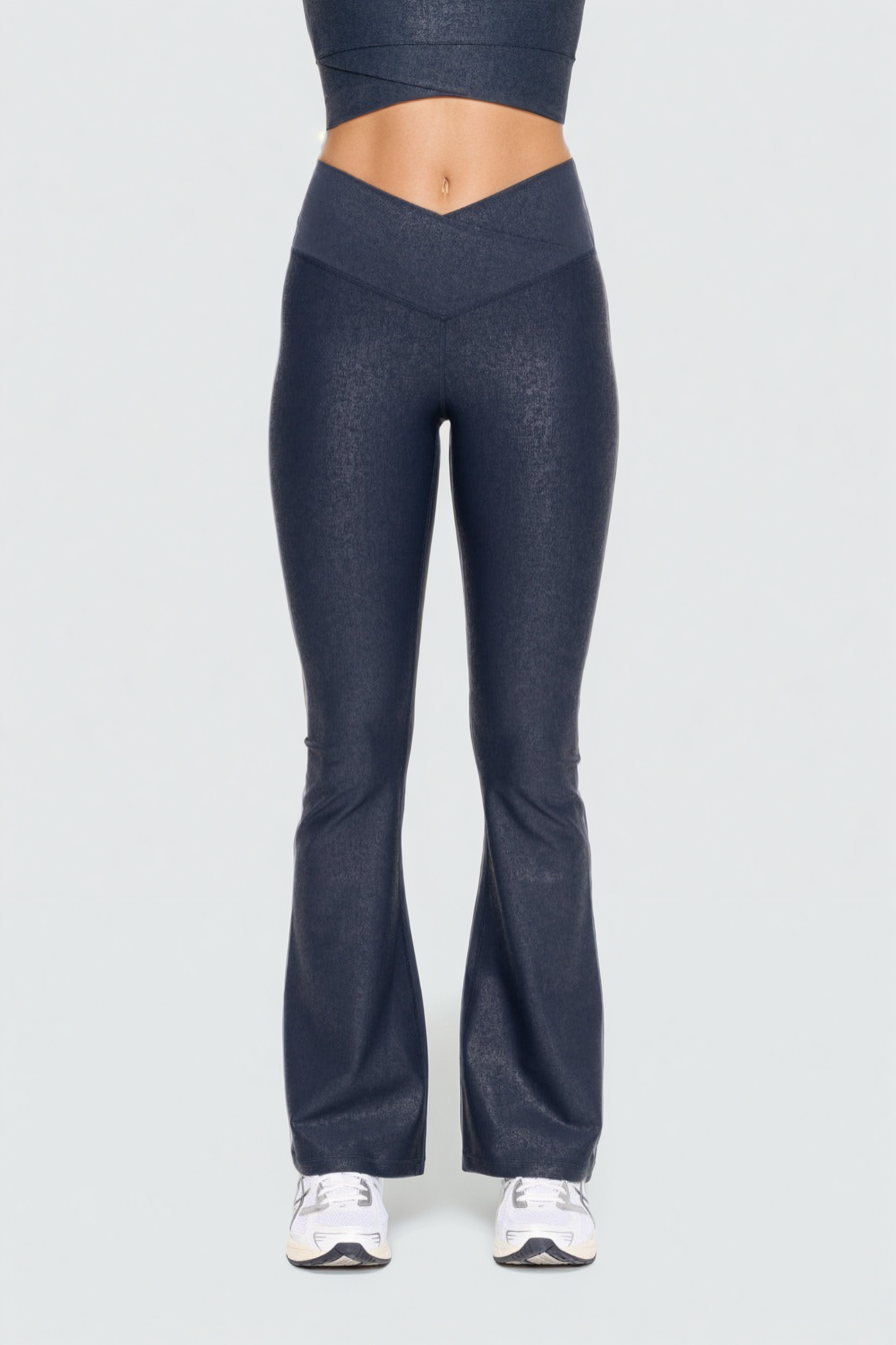 Black Luxe Edge leather-look crossover flare leggings by Fitkitty Culture, showcasing their stylish high-waist design and sleek fit.