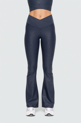 Black Luxe Edge leather-look crossover flare leggings by Fitkitty Culture, showcasing their stylish high-waist design and sleek fit.