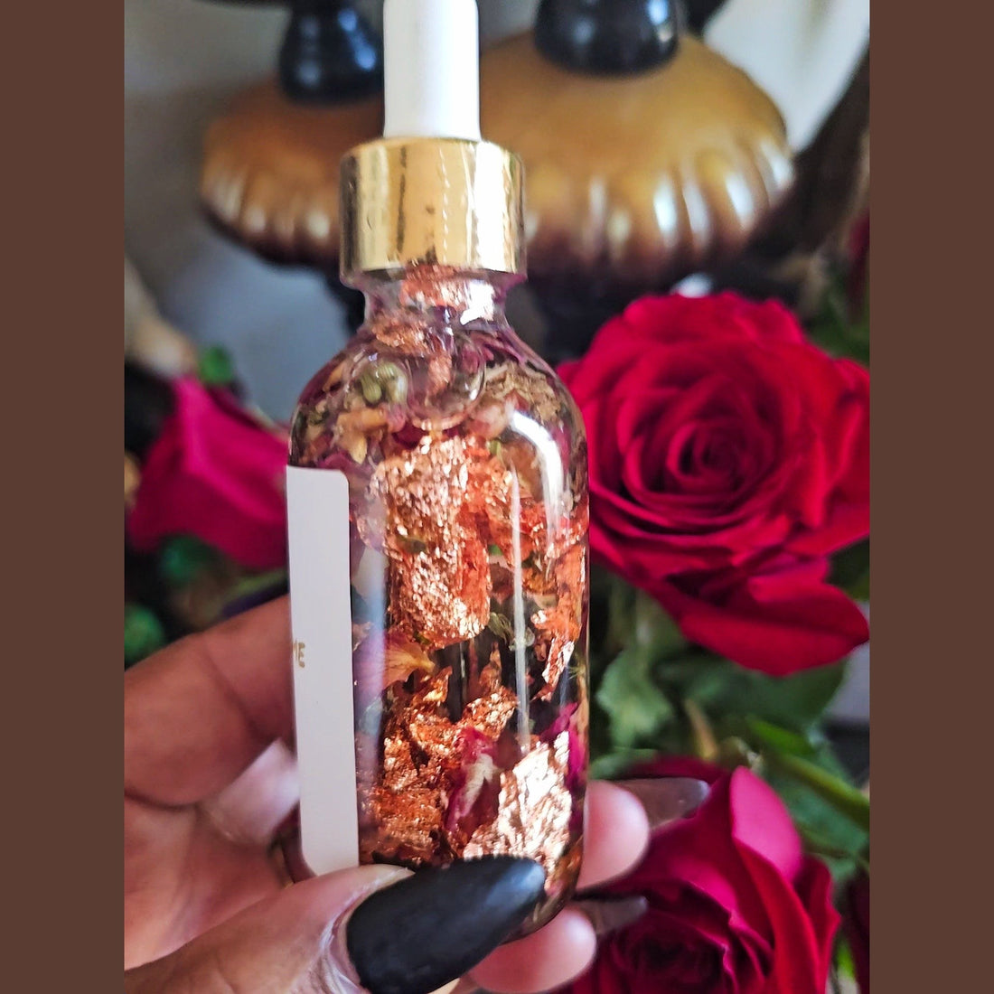Rich Bitch Conjure Come To Me Attraction Oil in a small glass bottle with a dropper, used for hoodoo attraction spells.