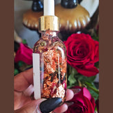 Rich Bitch Conjure Come To Me Attraction Oil in a small glass bottle with a dropper, used for hoodoo attraction spells.