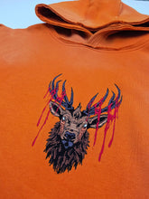 Orange Trophy Pullover Hoodie by Any Means Necessary Clothing, front view showing the hoodie’s design and comfortable fit.