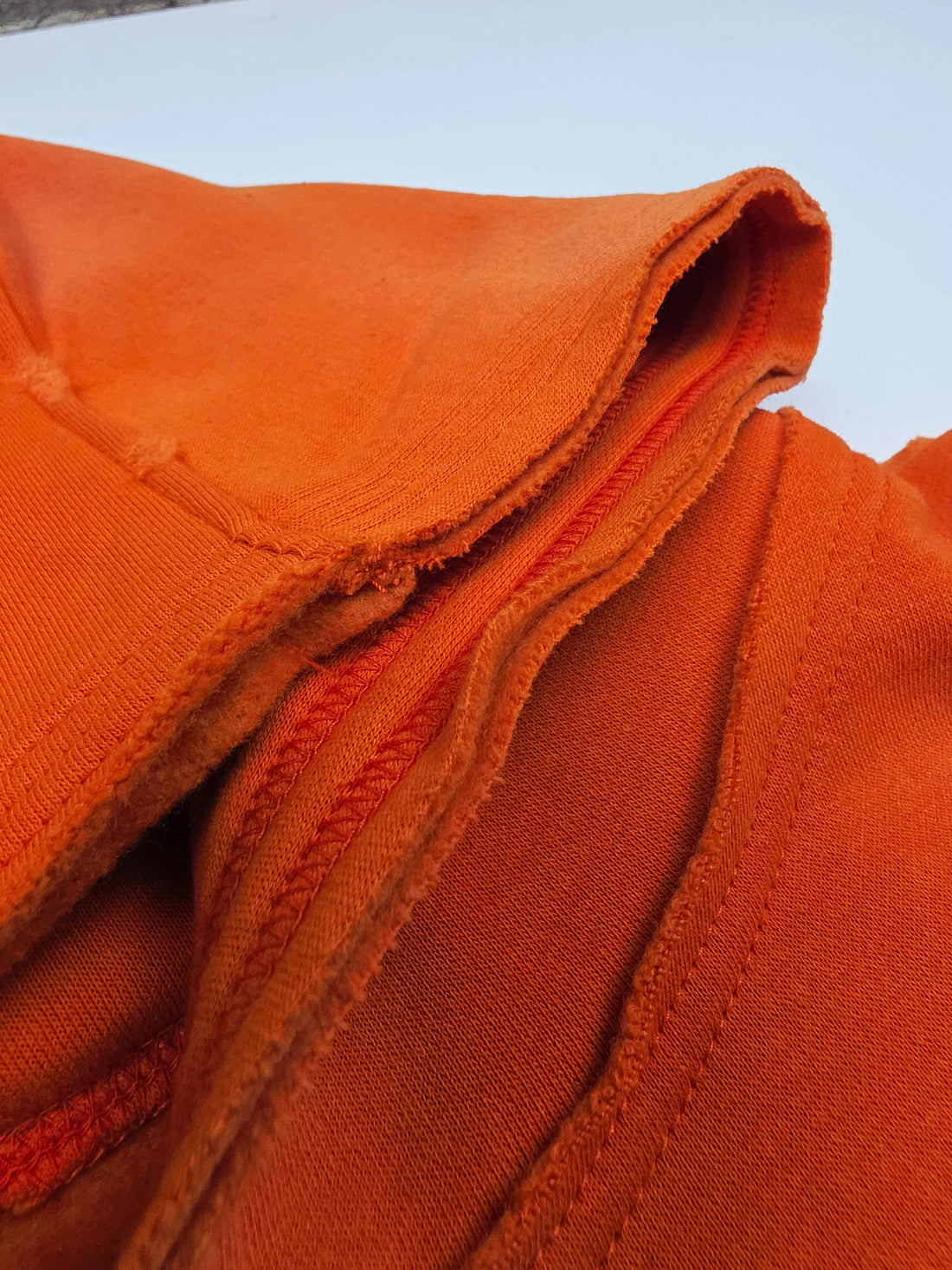 Orange Trophy Pullover Hoodie by Any Means Necessary Clothing, featuring a casual fit and comfortable fabric, displayed on a hanger.