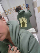 Sage green hoodie featuring "Hell is Empty" text design from Any Means Necessary Clothing, casual pullover style with hood and front pocket.