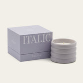 Soy wax ceramic candle by Italic, showing a white ceramic container with a lit wick and natural soy wax interior.