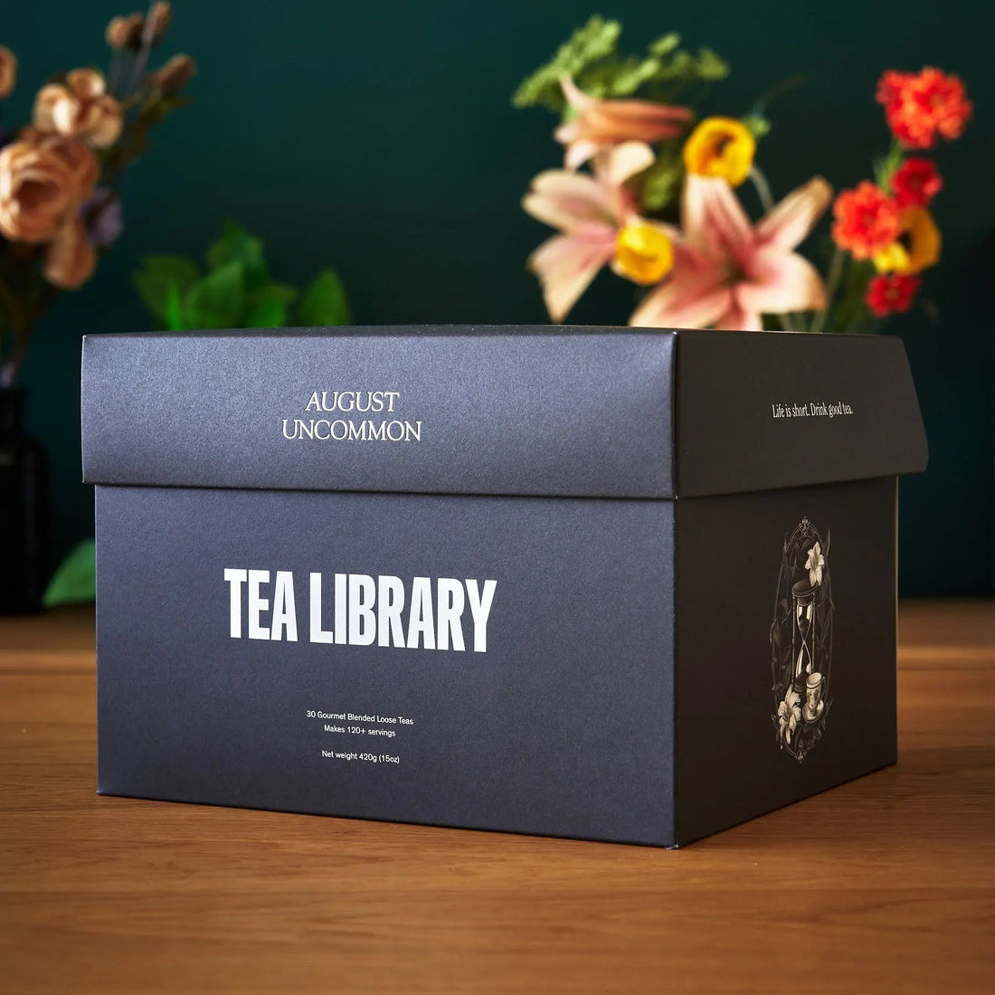 August Uncommon Tea Deluxe 30 Tea Sampler box with assorted loose leaf teas in a decorative packaging.