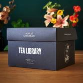 August Uncommon Tea Deluxe 30 Tea Sampler box with assorted loose leaf teas in a decorative packaging.
