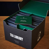 August Uncommon Tea Deluxe 30 Tea Sampler featuring a variety of loose leaf teas in an elegant box.