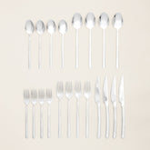 Italic Emilia 20-piece flatware set including forks, knives, spoons, and teaspoons arranged on a white background.