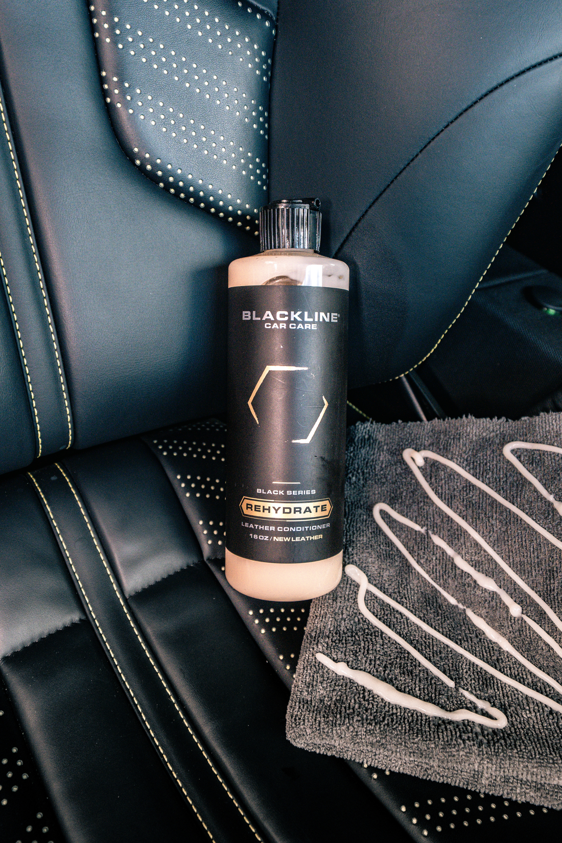 Blackline Car Care BLACKLINE® Rehydrate Leather Conditioner bottle, a leather conditioner for car seats and upholstery.
