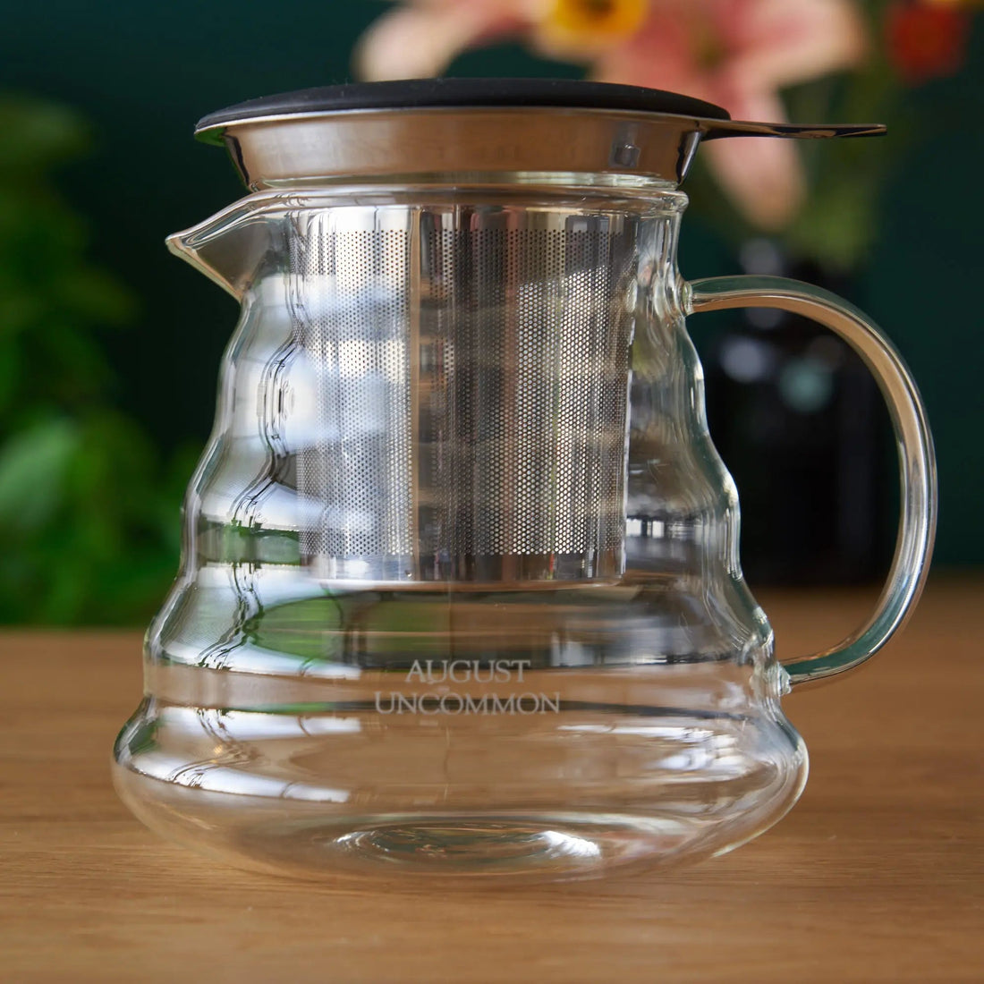 Two cup glass teapot from August Uncommon Tea, clear teaware with a sleek design, perfect for brewing and serving tea.