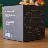 Two cup glass teapot from August Uncommon Tea, clear teaware with a sleek design for brewing and serving tea.