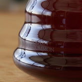 Two cup glass teapot by August Uncommon Tea, clear teaware with a simple design for brewing and serving tea.