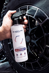 Blackline Car Care BLACKLINE® Blackout Trim & Tire Dressing applied to vehicle tires and trim for a sleek, polished look.