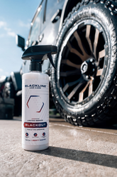 Blackline Car Care BLACKLINE® Blackout Trim & Tire Dressing applied to car tires and trim for a sleek, shiny finish.