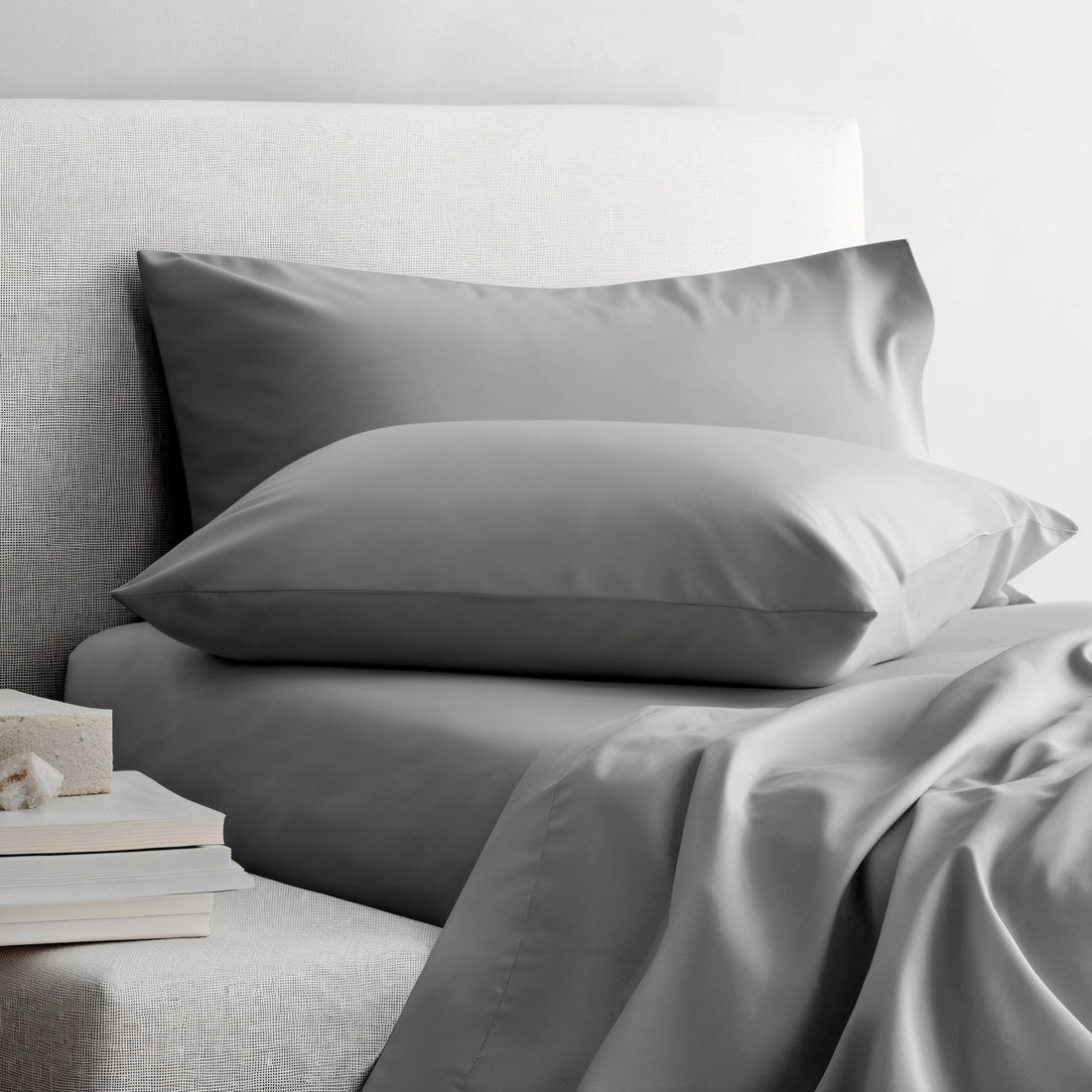 Smooth Luxe Australian Sateen Sheet Set by Italic on a bed with neatly arranged sheets and pillowcases in a cozy bedroom setting.