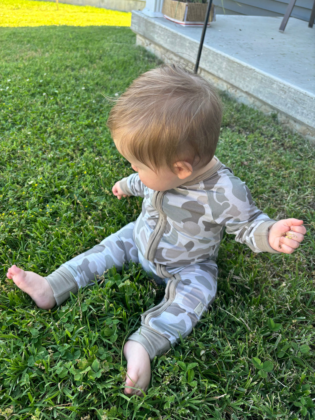 Baby zippy in Button Buck Camo pattern by Bow Crew Apparel, featuring a front zipper and camo design suitable for outdoor adventures.