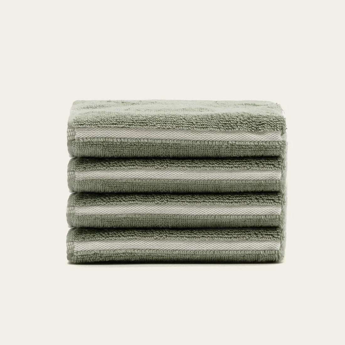 Set of four sage-colored Deia Australian Cotton Washcloths by Italic for home and bed use, soft and absorbent.