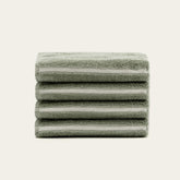 Set of four sage-colored Deia Australian Cotton Washcloths by Italic for home and bed use, soft and absorbent.