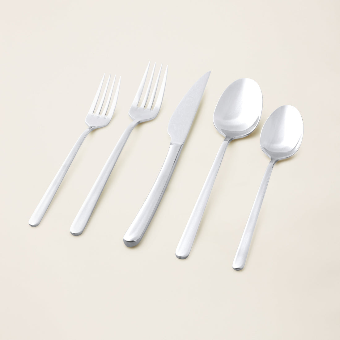 Italic Emilia Mirror 20-piece flatware set featuring stainless steel forks, knives, spoons with a sleek, polished finish.