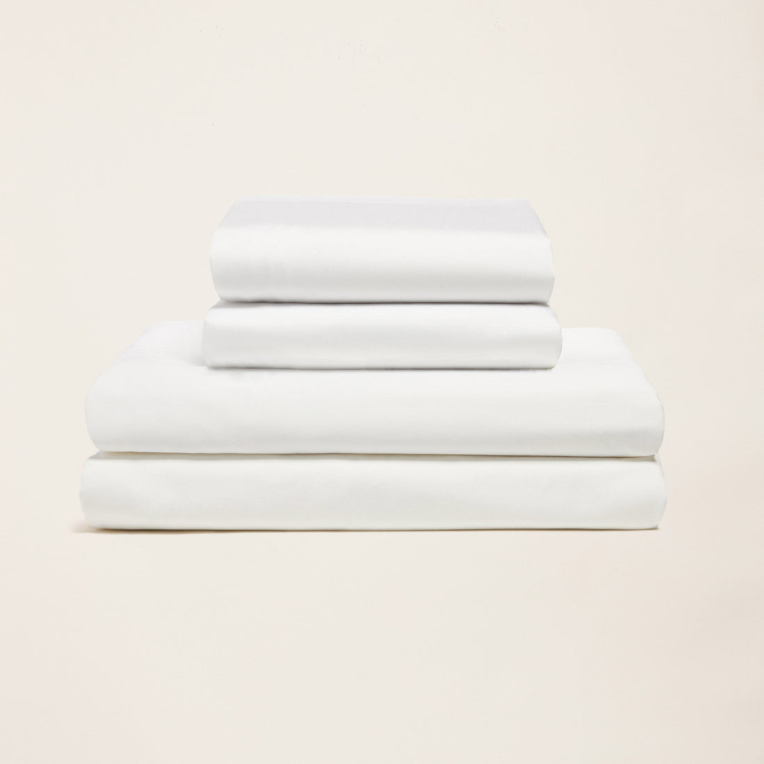 Italic Luxe Australian Sateen Sheet Set displayed on a bed with smooth, shiny satin fabric and neatly arranged pillows.