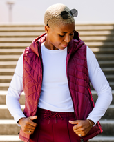 Goal Five Powerstripe Eco-Friendly Down Hooded Vest shown in lifestyle setting with quilted design and hood, highlighting warmth and style.