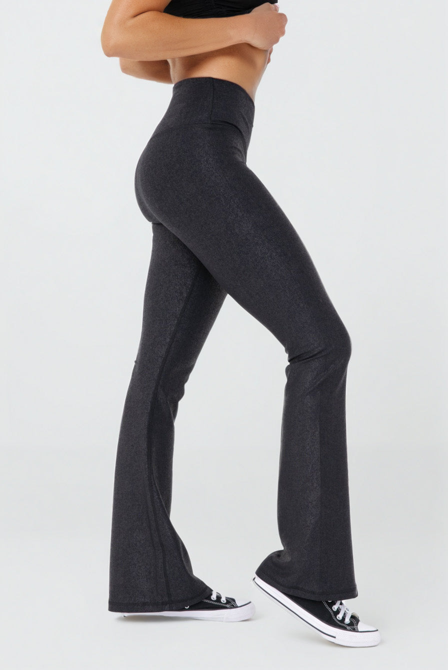 Black Luxe Edge leather-look crossover flare leggings from Fitkitty Culture athleisure wear, showing their stylish high-waist design.