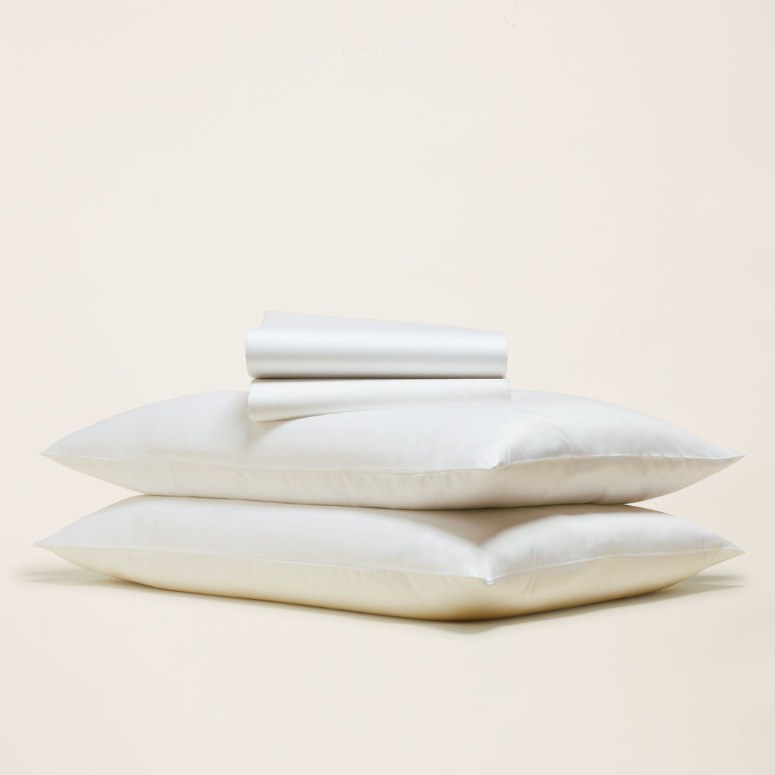 Smooth Luxe Australian Sateen Sheet Set from Italic, featuring soft, shiny bed sheets with a neatly made bed and plush pillows.