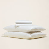 Smooth Luxe Australian Sateen Sheet Set from Italic, featuring soft, shiny bed sheets with a neatly made bed and plush pillows.