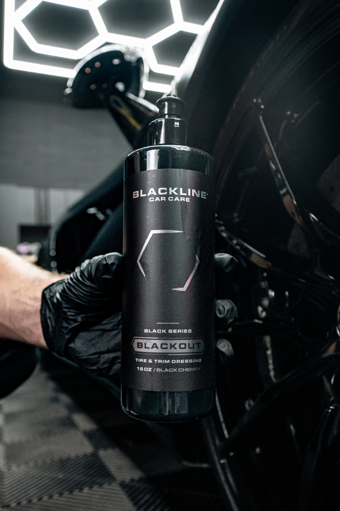 Blackline Car Care BLACKLINE® Blackout Trim and Tire Dressing applied to vehicle tires and trim for a sleek, matte finish.