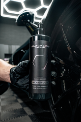 Blackline Car Care BLACKLINE® Blackout Trim and Tire Dressing applied to vehicle tires and trim for a sleek, matte finish.